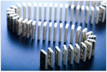 Undisturbed dominoes hold potential energy, but once you push one, each domino's potential energy is converted to kinetic energy as it falls.