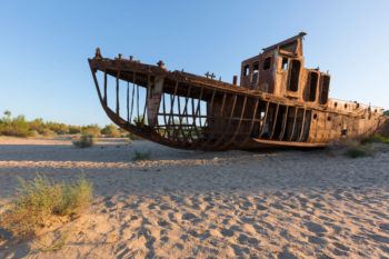 We see an example of changes in ecosystems when we see an old, rusty boat in the middle of a desert (previously full of water).