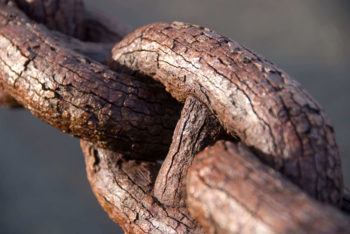 Due to chemical reactions, the arrangement of atoms on a rusting chain may change over time.