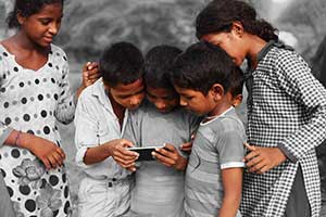 Kids around tablet playing online educational games