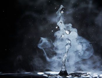 Water particle motion creating a droplet of water with black background