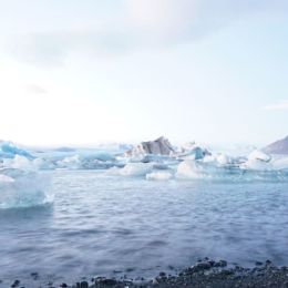 Iceberg's in ocean water with white sky