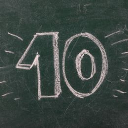 the number 10 written on a green chalkboard with decorative lines around it