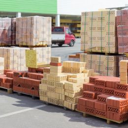 many pallets of yellow and red bricks