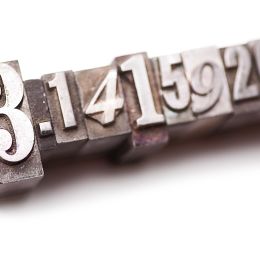the number pi engraved on gray metal blocks
