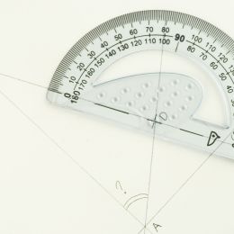 geometric shape being drawn with a protractor with line markings on white paper