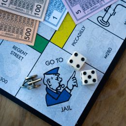 Go To Jail space shown on a monopoly board with dice