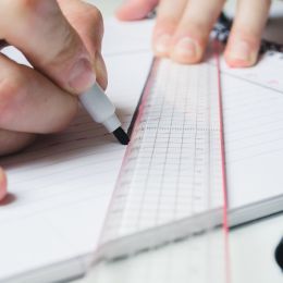 straight line being drawn with a marker using a ruler