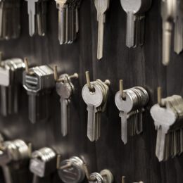 silver keys hanging on hooks at a store