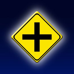 yellow crossroads road sign on a blue background