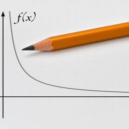 curved graph showing decreasing trend with a pencil on top of it