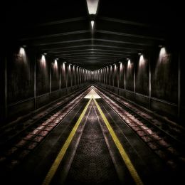 dark underground tunnel for trains with rows of underground lights