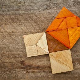 brown wooden geometric blocks arranged into squares