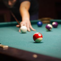 player hitting pool ball