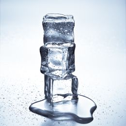 3 ice cubes stacked on top each each other, starting to melt
