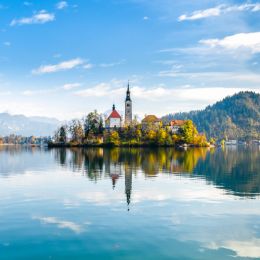 island with buildings being reflected in water