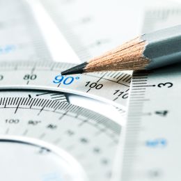 pencil laying on ruler and protractor