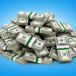 large pile of cash in front of a blue ombre background
