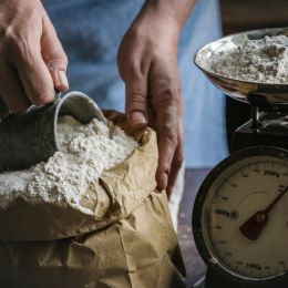 person taking flour out of a bag