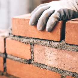 person laying bricks