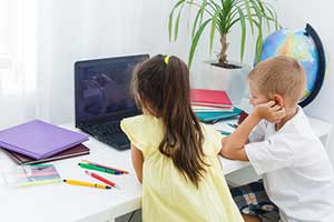 Children using online educational games in their distance learning class