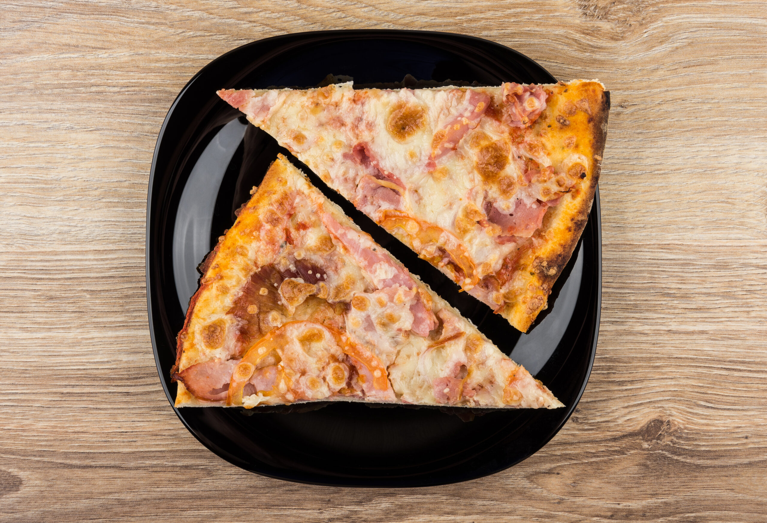 two triangle slices of pizza composed into rectangle