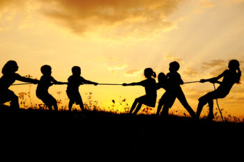 kids playing tug of war comparing their strength