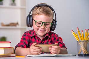 Boy playing an online educational game during remote learning