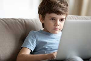Child focused on his online educational game